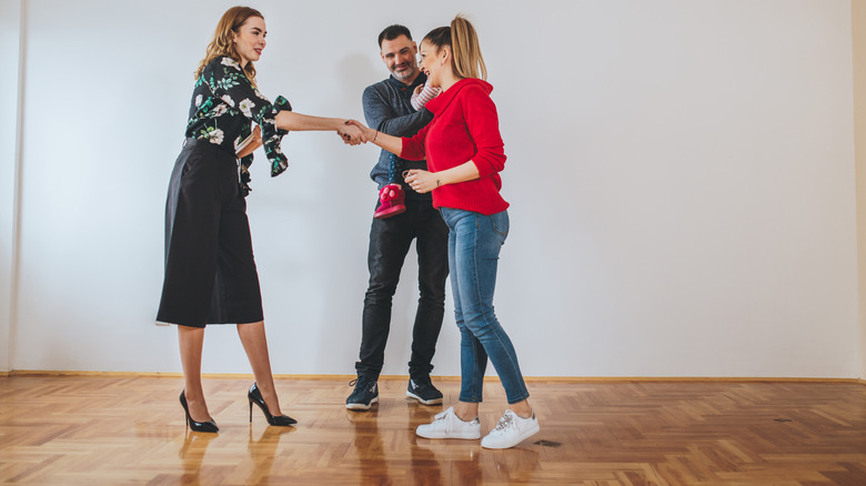 Realtor shaking hands in room