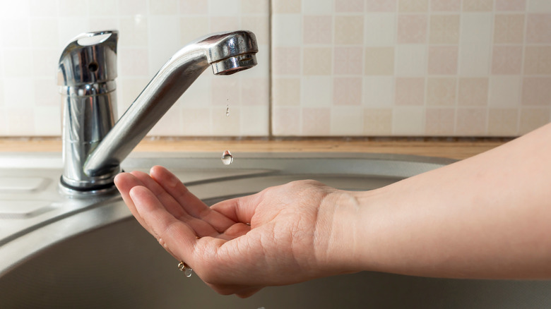 faucet dripping in hand