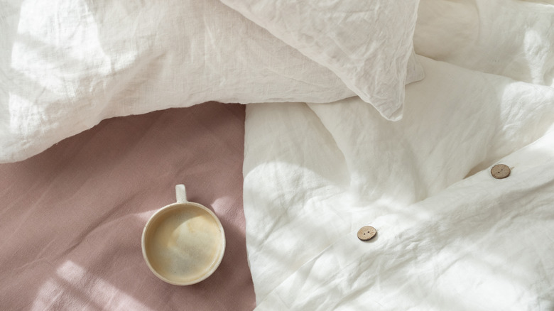 Wrinkled linen bedding and coffee