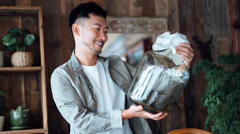 Person looking at glass vase