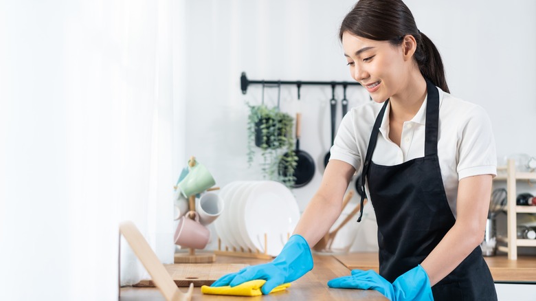 person cleaning countertop