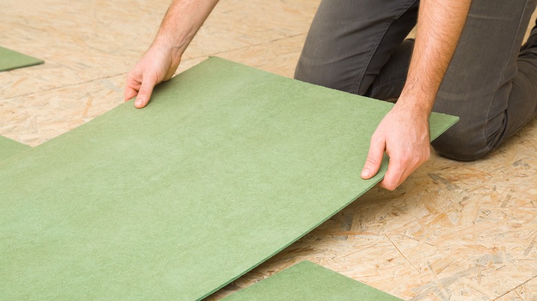 Person installing subfloor