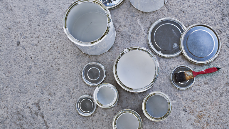 open paint cans and lids