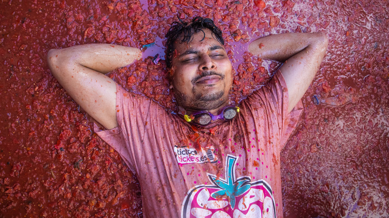 Person lying in tomato puddle