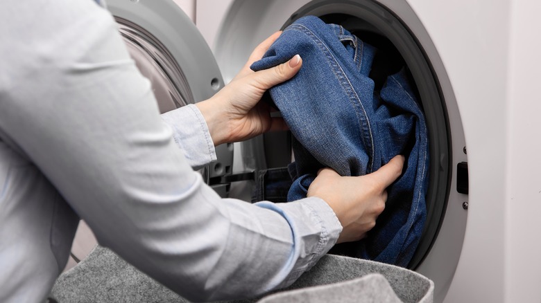 Putting jeans in the washer