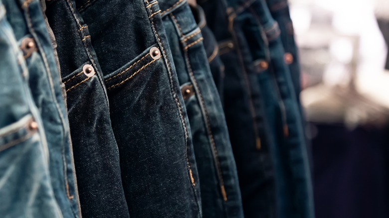 Assortment of dark denim jeans