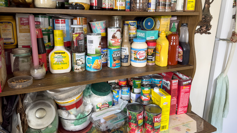 Messy pantry of various foods, including dry goods.