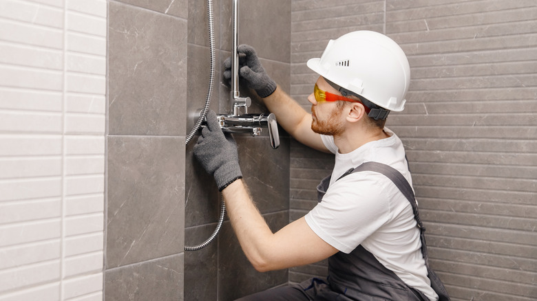 A plumber installing a shower 