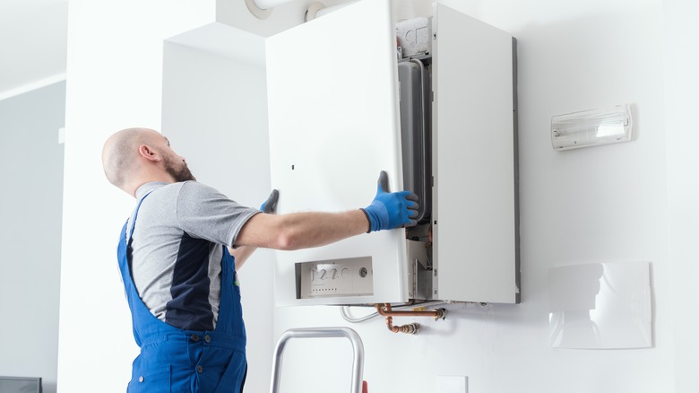 A plumber working on a boiler 