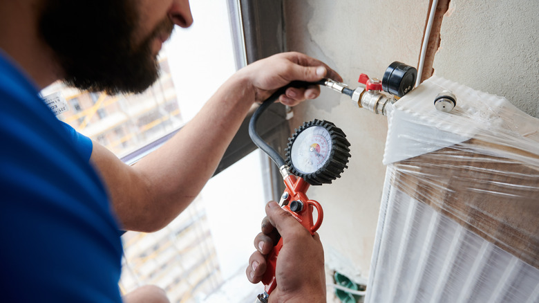 A plumber checking for gas leaks 