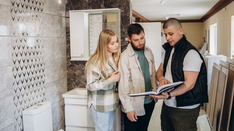 A couple going over a bathroom design with a showroom consultant