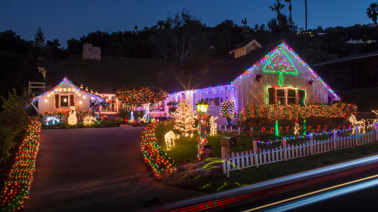 Exterior of home decorated with lots of Christmas lights and holiday statues