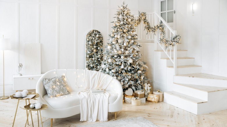 Minimalist white living room decorated for Christmas with white decorations