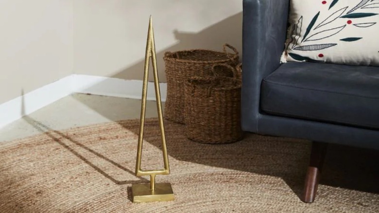 Minimalist gold metal triangle tree in simple living room