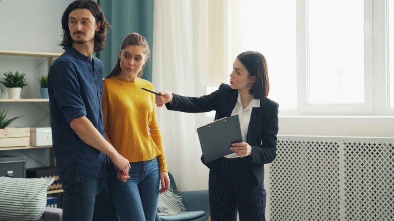 A couple looks at a home with a real estate agent