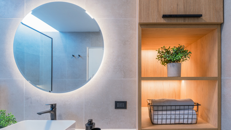 lighted bathroom mirror and shelves