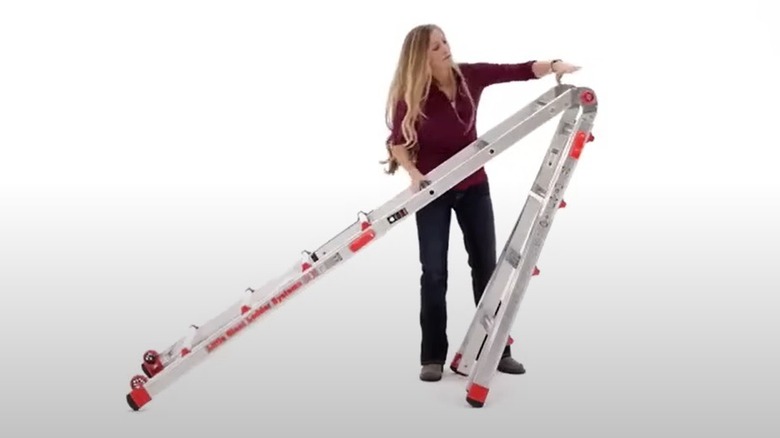 Woman adjusting telescoping ladder