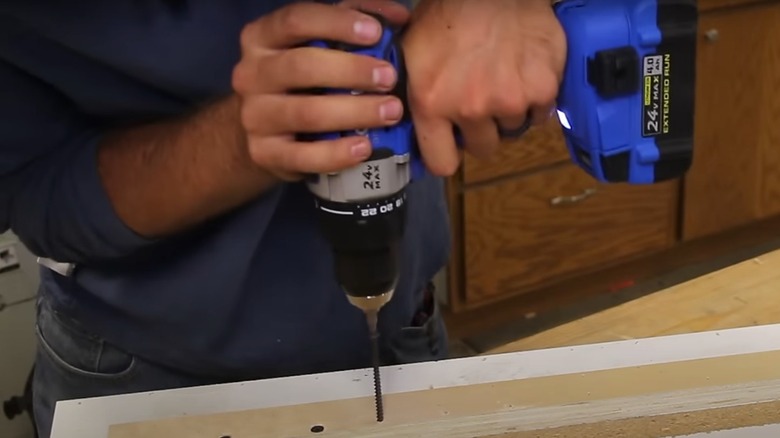 person using a cordless drill