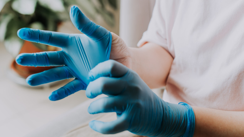 Woman putting on gloves