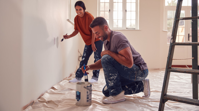 Couple painting a room