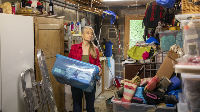 Woman carrying plastic container