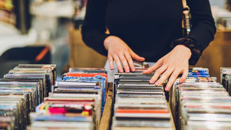 Someone looking through their CD collection