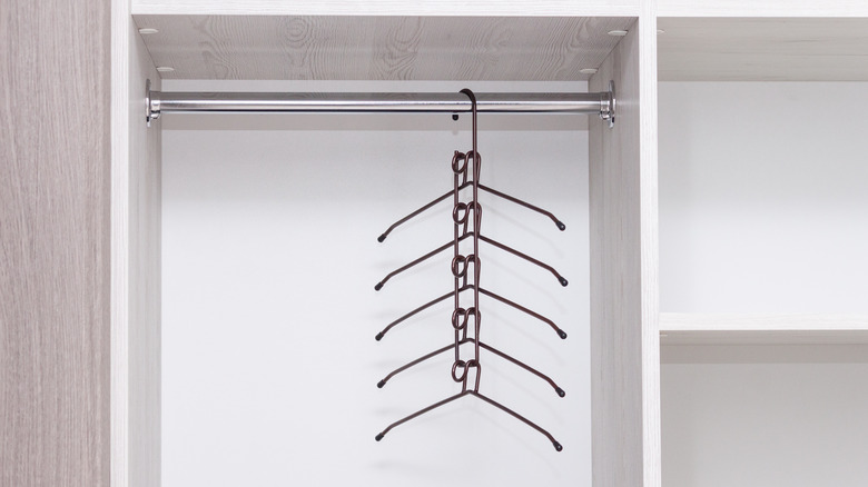 brass multi-tier hanger in closet