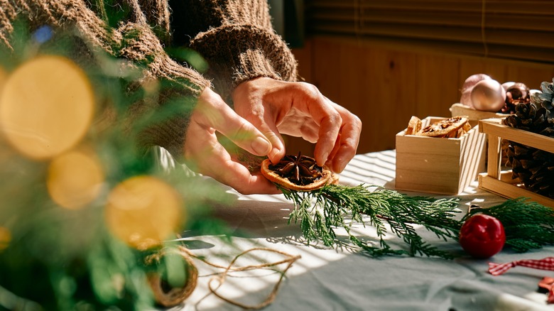 person making fir arrangement