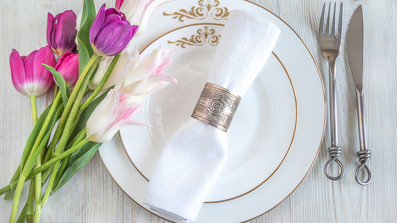 silver napkin ring on white napkin