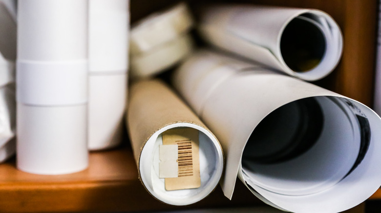 white posters rolled on shelf