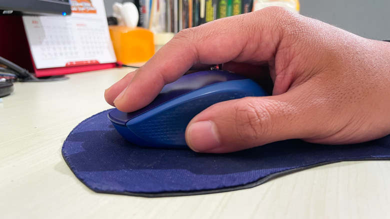 Hand using mouse on DIY mousepad