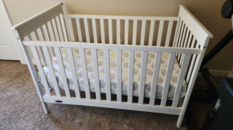 A small mattress inside a crib