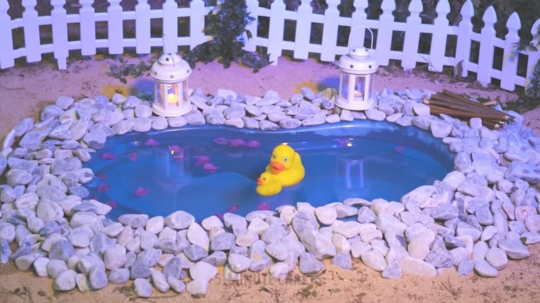 Water feature made of baby bathtub with gravel and floating yellow duckies