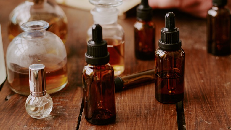 Collection of essential oil bottles on wooden surface