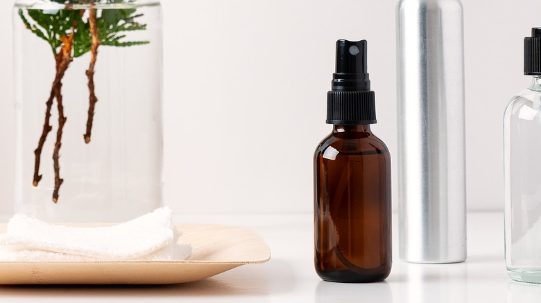 Close up of small amber bottle with spray bottle lid.