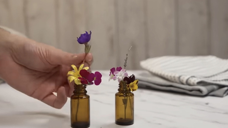 Small flowers inside of doTERRA essential oil bottles.