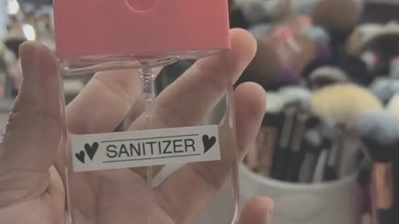 Closeup of a person holding a DIY hand sanitizer bottle