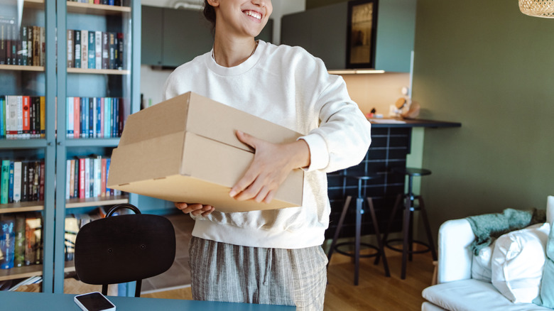 Person carrying cardboard boxes