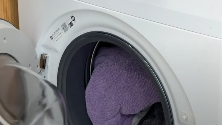 A microfiber towel has been added to a load of laundry in the dryer to capture lint