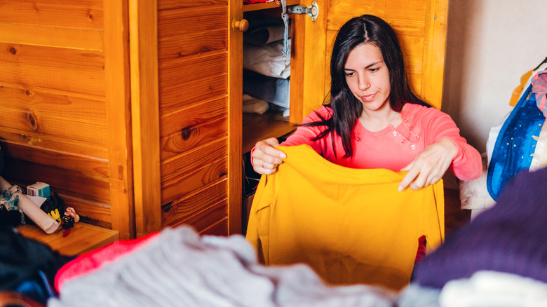 woman folding shirt