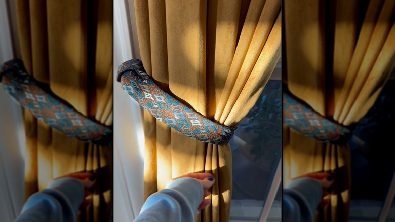 Curtains tied back with an old repurposed tie