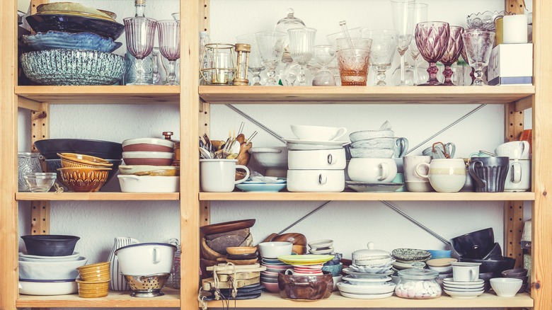 Kitchen shelves filled with old cookware and dishware