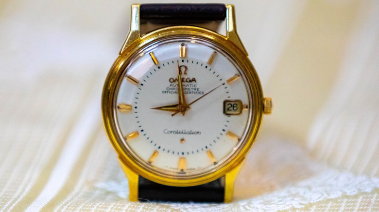 Old Omega men's watch on a white cloth