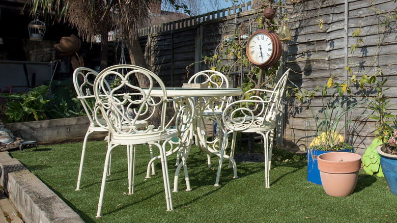 clock affixed to garden fence