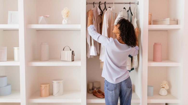 woman organizing an open closet