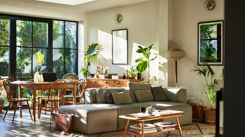 A residential living room with a large glass door opening to the garden.