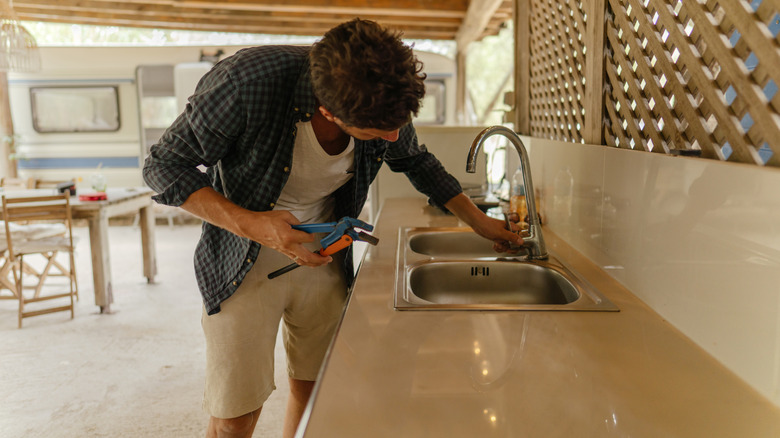 Man fixing outdoor sink