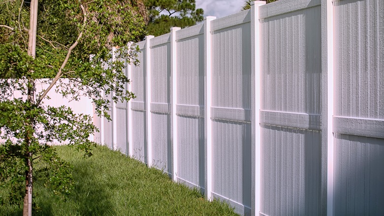 A tall white privacy fence