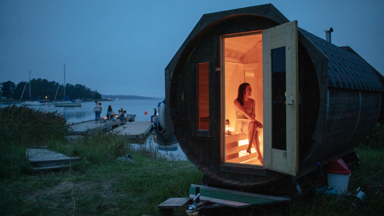 Woman using outdoor sauna at night