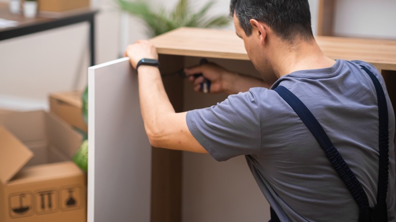 Person working with cabinet doors